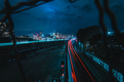 High angle view of light trails on road in city at night