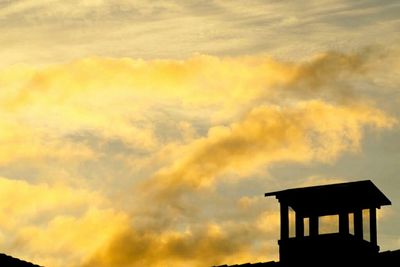 Low angle view of cloudy sky at sunset