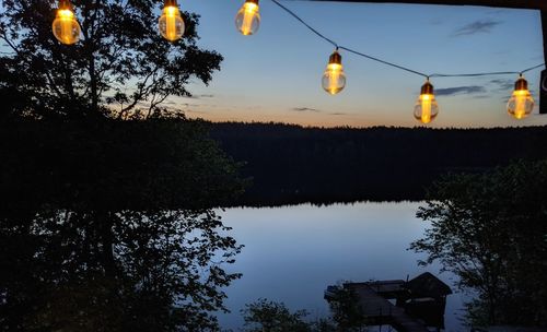 Scenic view of lake against sky at dusk