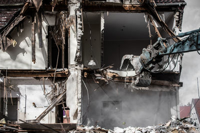 Machinery demolishing building