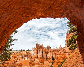 Rock formation against clouds