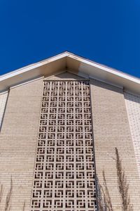 Low angle view of building against clear blue sky