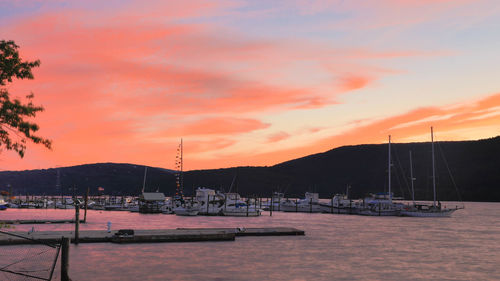 Boats in harbor at sunset