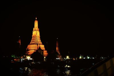 Illuminated temple against clear sky at night