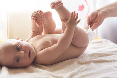 High angle view of baby lying on bed