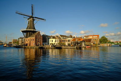 Haarlem. the famous adriaan windmill on the river de spaarne on a clear day.