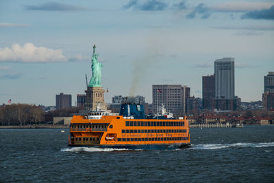 Ferry boat in hudson river against statue of liberty