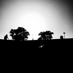 Low angle view of silhouette trees against sky at sunset