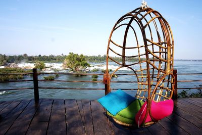 Umbrellas against sea against clear sky
