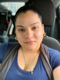 Portrait of smiling woman sitting in car