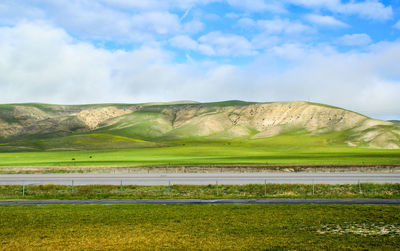 Scenic view of mountains against cloudy sky