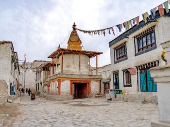 People walking on street amidst buildings in town
