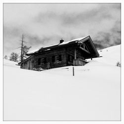 Snow covered buildings against sky