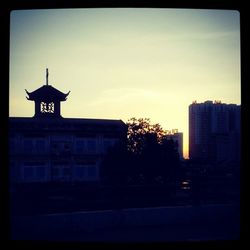 Buildings in city at sunset