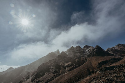 Low angle view of snowcapped mountains against sky