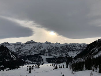 View of snowcapped mountain against cloudy sky