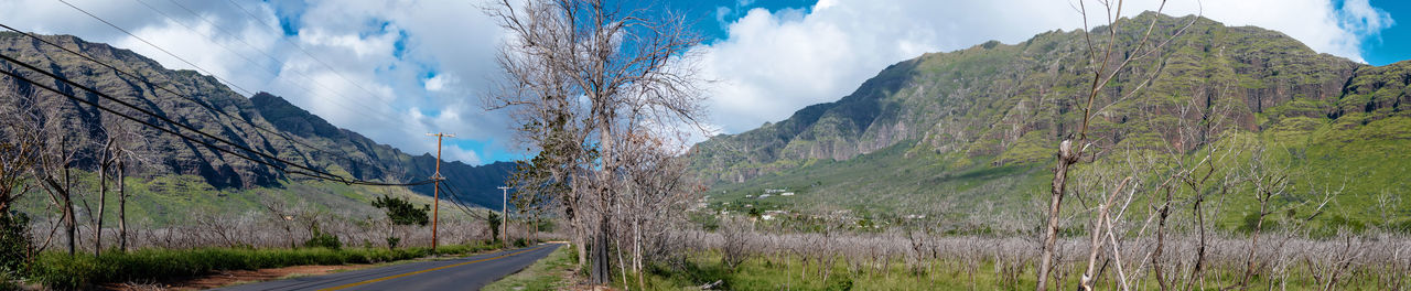 Panoramic view of road by mountains against sky