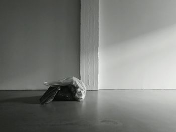 Side view of woman dancing against white wall