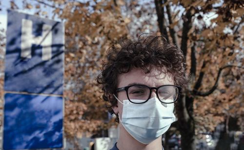 Portrait of boy wearing mask standing outdoors