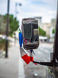 Close-up of umbrella hanging in city