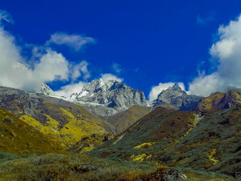 Scenic view of snowcapped mountains against blue sky