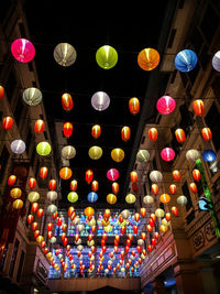 Low angle view of illuminated lanterns hanging at night