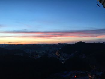 Scenic view of silhouette mountains against sky at sunset