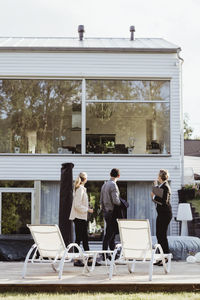 Side view of real estate agent showing new property to couple