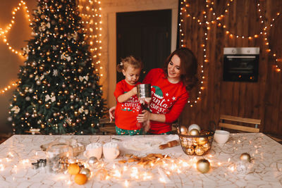 Rear view of woman holding christmas tree