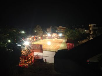 Low angle view of illuminated buildings against sky at night