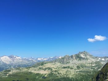 Scenic view of mountains against blue sky