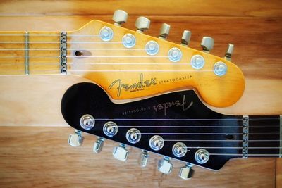 Close-up of guitar on white wall