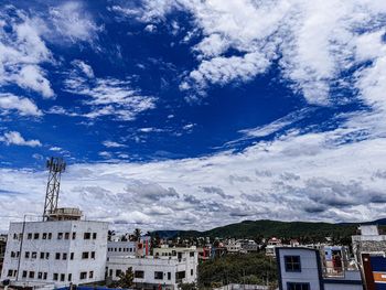 Low angle view of buildings in town against sky