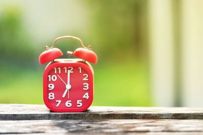 Close-up of alarm clock on wooden table