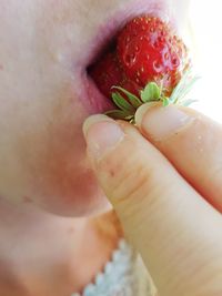 Close-up of hand holding strawberry