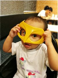 Close-up portrait of cute boy playing at home