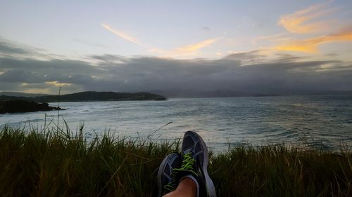 Scenic view of lake against cloudy sky