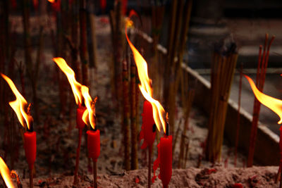 Close-up of burning candles in temple