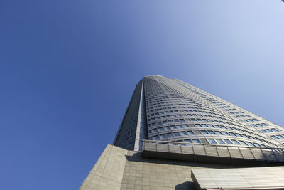 Low angle view of modern building against clear blue sky