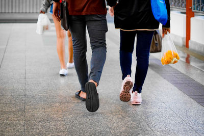 Low section of people walking on footpath