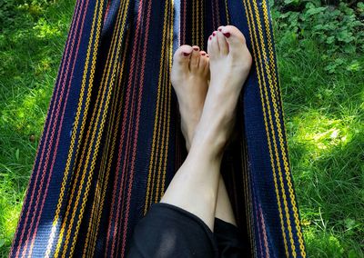 Low section of woman relaxing on hammock