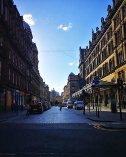 City street and buildings against sky