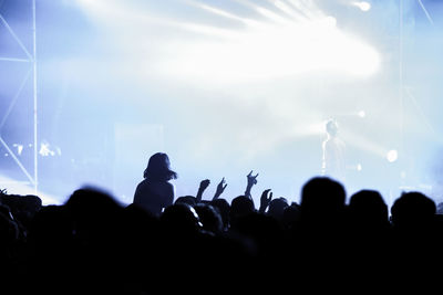 Group of silhouette people at music concert