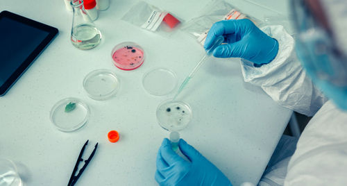 Scientist in protective suit working over chemical at laboratory