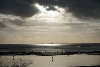Scenic view of sea against cloudy sky