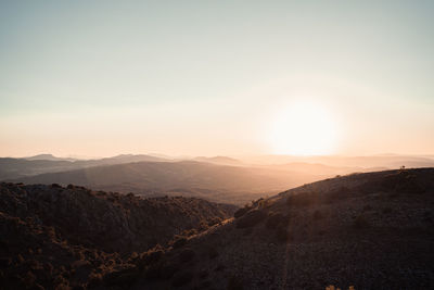 Scenic view of mountains against sky during sunrise