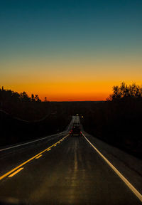 Road against clear sky during sunset