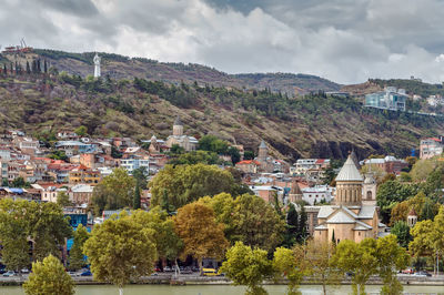 View of town against cloudy sky