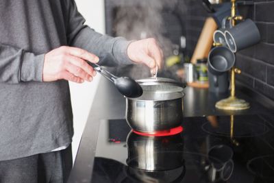 Midsection of man preparing food at home