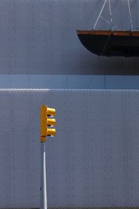 Close-up of telephone booth against blue sky